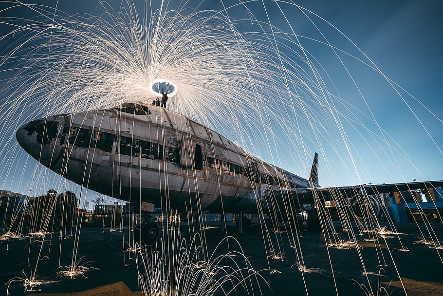 time lapse photo of steel wool and plane, gray and black airplane HD wallpaper