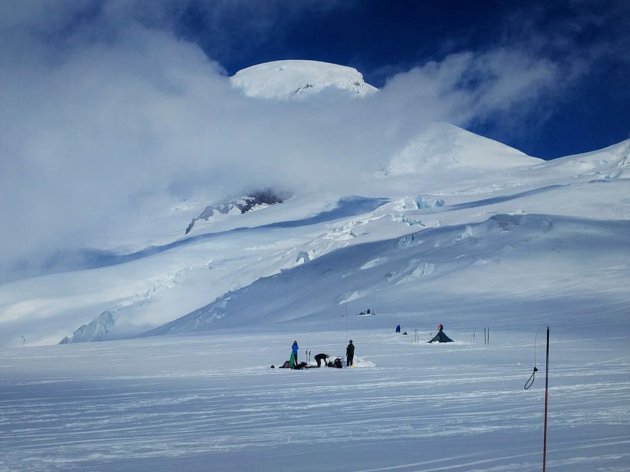 Mt. Baker playing hide and seek with clouds, persons on snow HD wallpaper