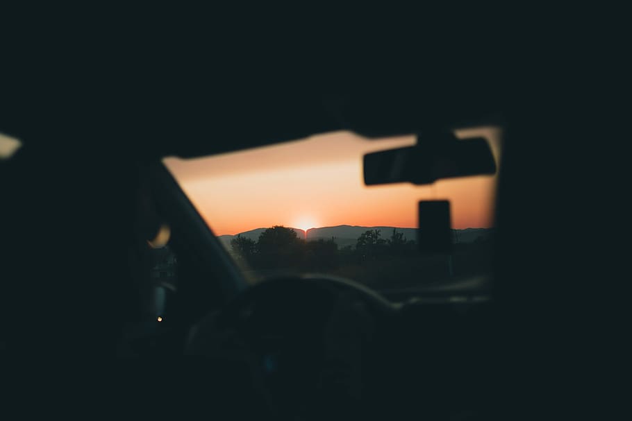 person in car seeing sunset, silhouette photo of trees during sunset HD wallpaper