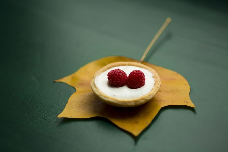 red berry on top of cream in shallow focus photography, two red raspberries on white surface HD wallpaper