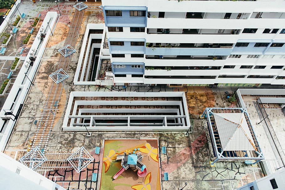 playground between tall buldings, aerial photography of building HD wallpaper