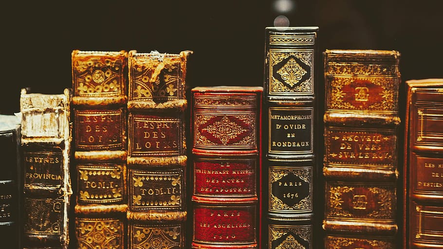 seven hardbound books on black surface, selective focus photography of books HD wallpaper