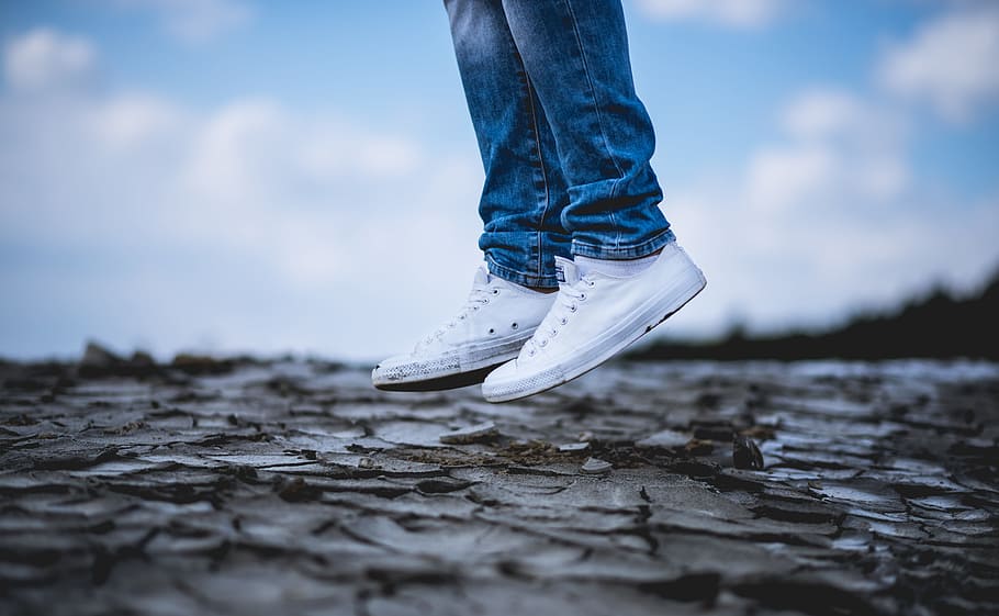 person wearing white low-top sneakers, person jumping on dried land, HD wallpaper