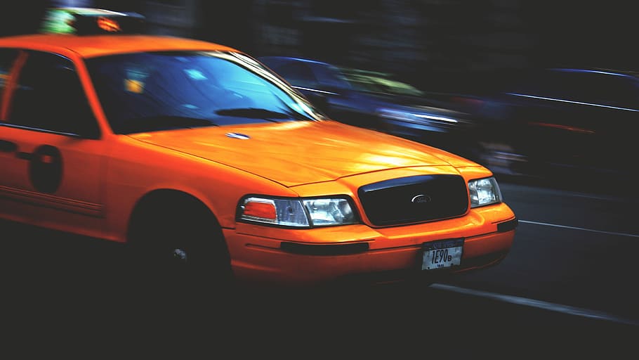 timelapse photography of orange car on black asphalt pavement HD wallpaper