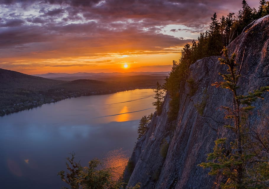 gray cliff near body of water during golden hour, gray mountain cliff near lake during cloudy sky HD wallpaper