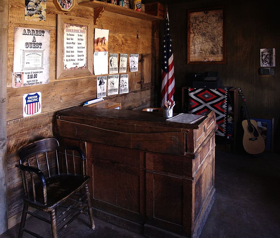 brown wooden desk white chair near USA flag, sheriff, office