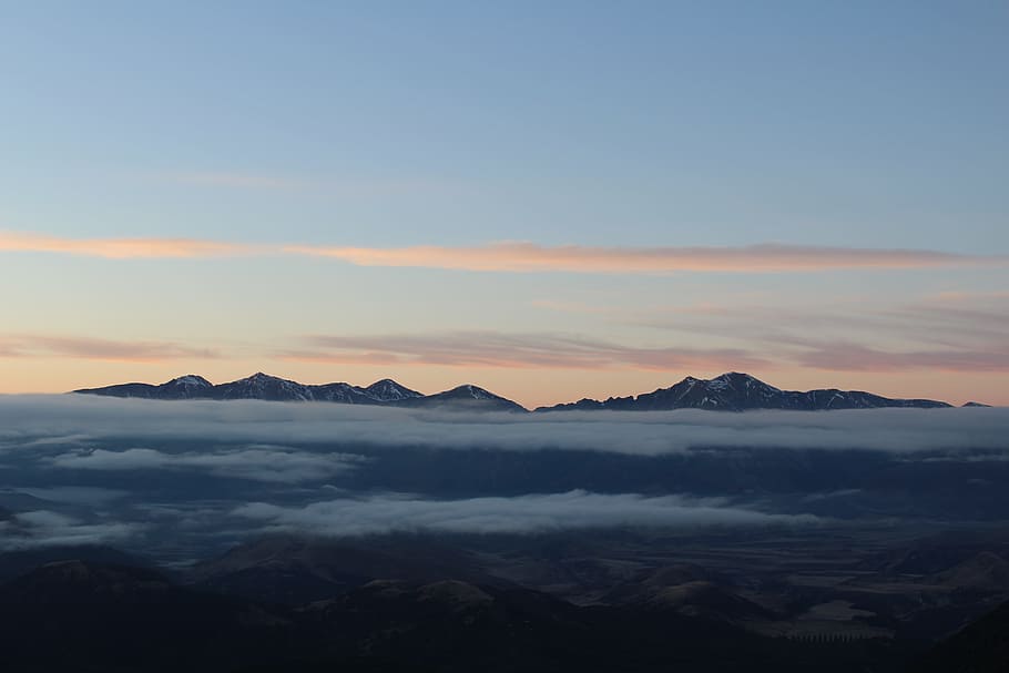 landscape photography of mountain, cloudy sky above mountains at sunset HD wallpaper