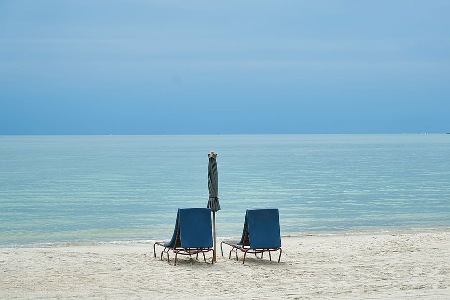 two empty blue beach lounger overlooking the seat under blue sky HD wallpaper