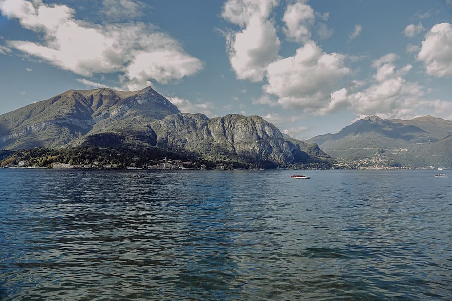 Body of Water Near Mountain, bay, beach, boat, clouds, daylight HD wallpaper
