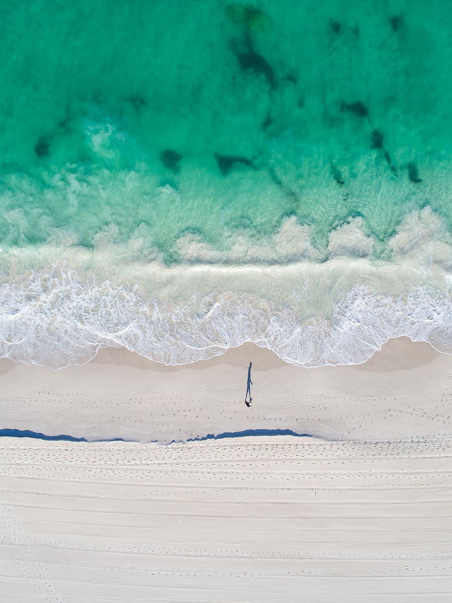 bird's eye view of body of water, aerial photo of person walking on beach during daytime HD wallpaper