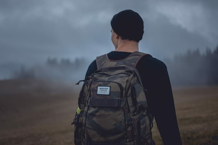 man carrying gray camouflage backpack, man carrying camouflage backpack HD wallpaper