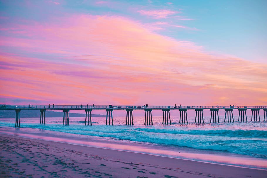 bridge under brown and blue sky, grey bridge on ocean, sunset HD wallpaper