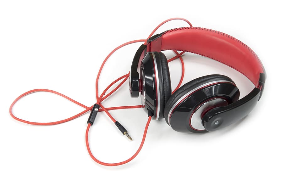 red and black corded headphones on white tabletop, music, listening