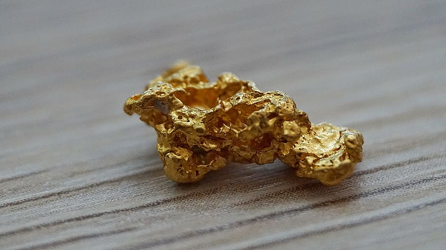 selective focus photography of gold-colored stone, gold nugget