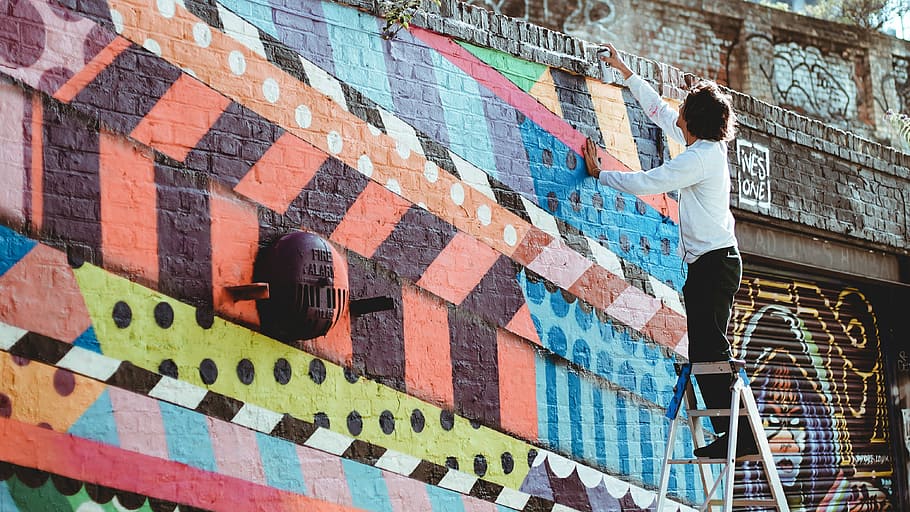 man standing on top of A-frame ladder, man in white shirt on ladder about to climb in graffiti wall, HD wallpaper