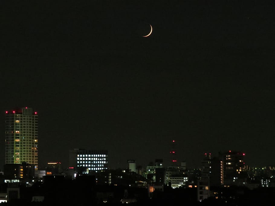 city skylines at night with moon