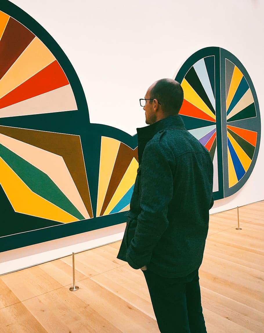 man in black shirt standing in front of wall art, men, jacket HD wallpaper
