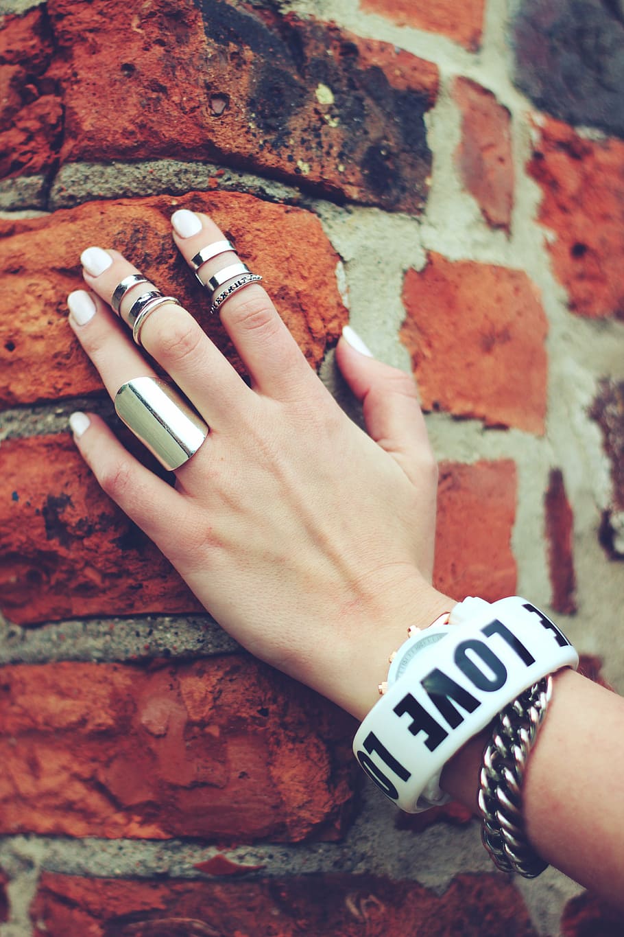 several silver-colored rings, hand, bricks, nails, bracelet HD wallpaper