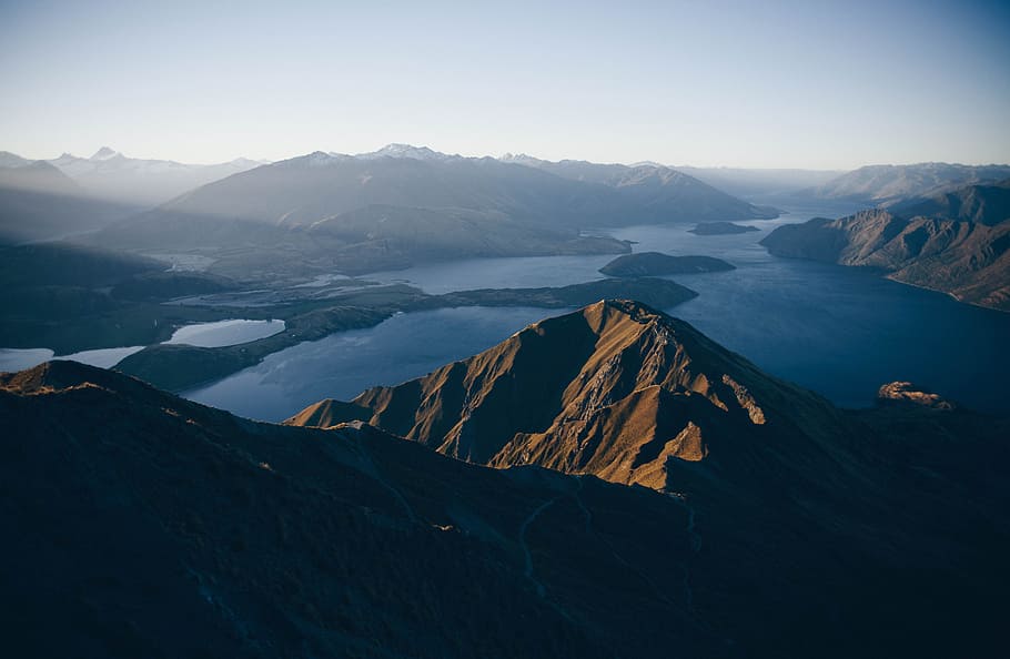 mountains surrounded body of water, aerial view photography of mountain and body of water during daytime HD wallpaper