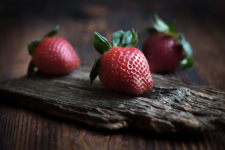 selective focus photo of red strawberry on brown wooden board, HD wallpaper