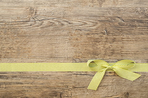 yellow and white plaid ribbon lace on brown wooden surface HD wallpaper