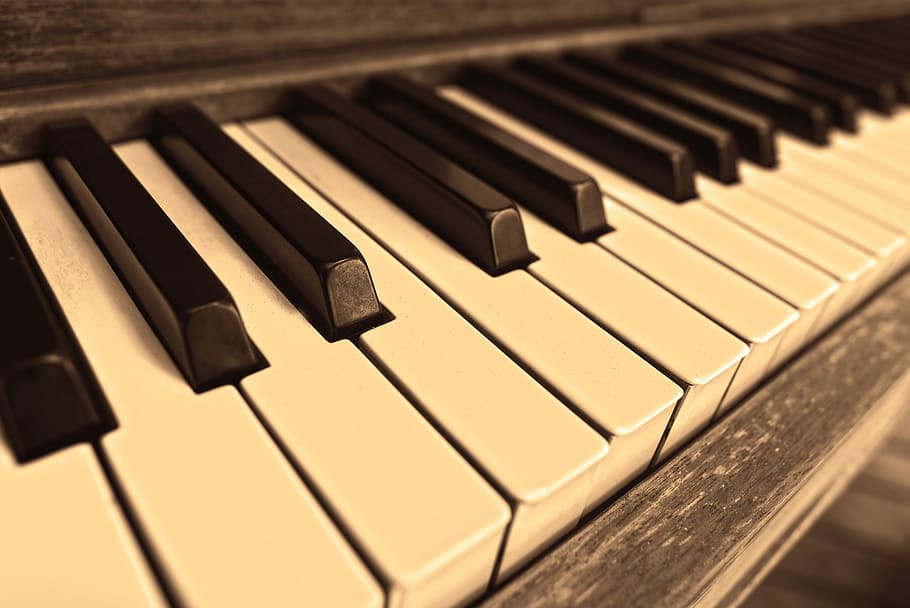 brown wooden upright piano in macro lens photography, piano keys