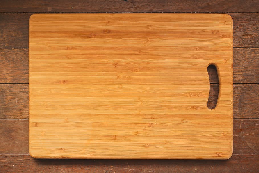 rectangular brown wooden chopping board on hardwood, kitchen