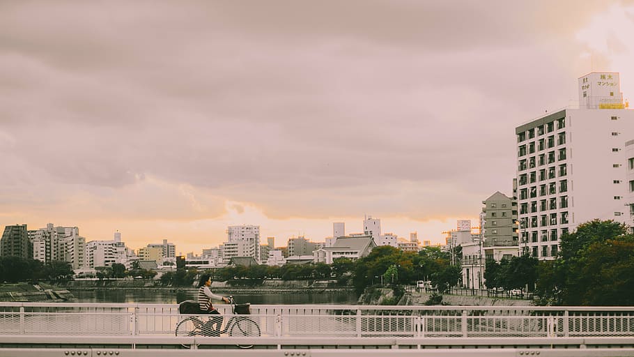 photography of person riding a bike on bridge, architecture HD wallpaper