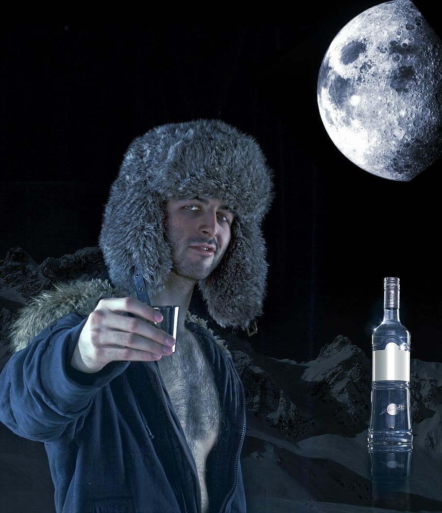 man holding gray shot glass during full moon, vodka, ad, alcohol