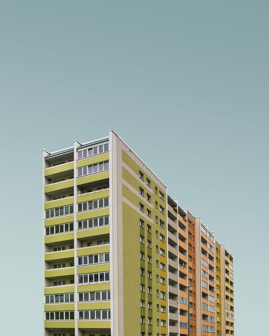 low-angle photography of white, green, pink, and brown concrete buildings, green and white high-rise building HD wallpaper