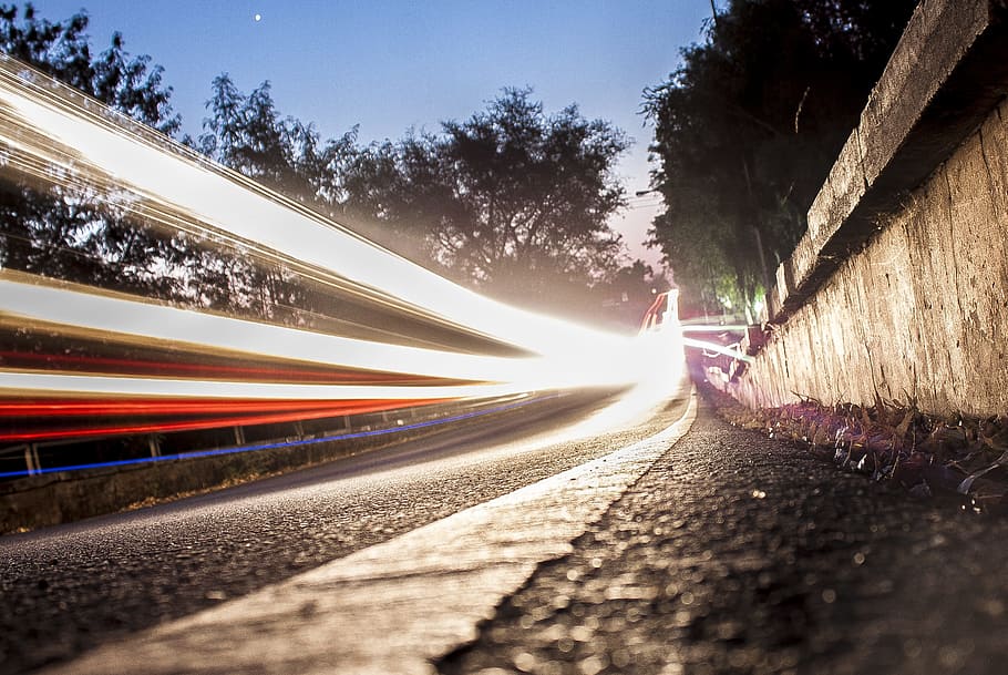 timelapse photography of vehicle running on road at daytime HD wallpaper