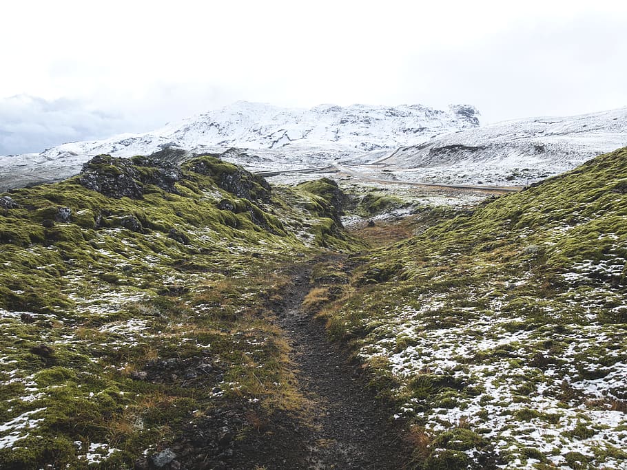 pathway between green grass hill towards snow capped mountain, aerial view of green and white field HD wallpaper