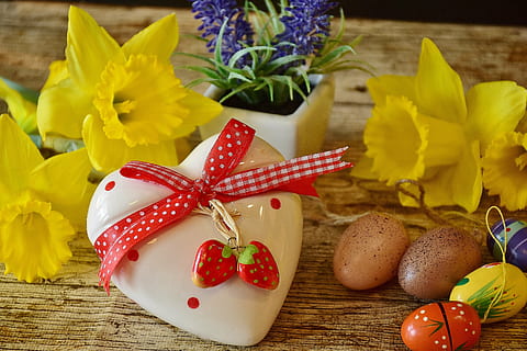 white and red ceramic heart lid near two yellow flowers on brown wooden surface HD wallpaper