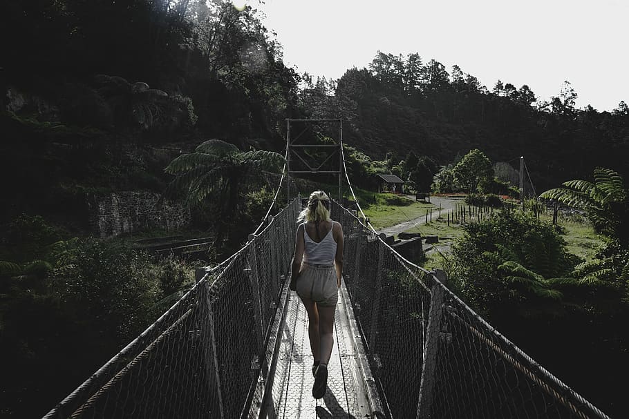 woman in white tank top waling in bridge during daytime, woman walking on hanging bridge during daytime HD wallpaper