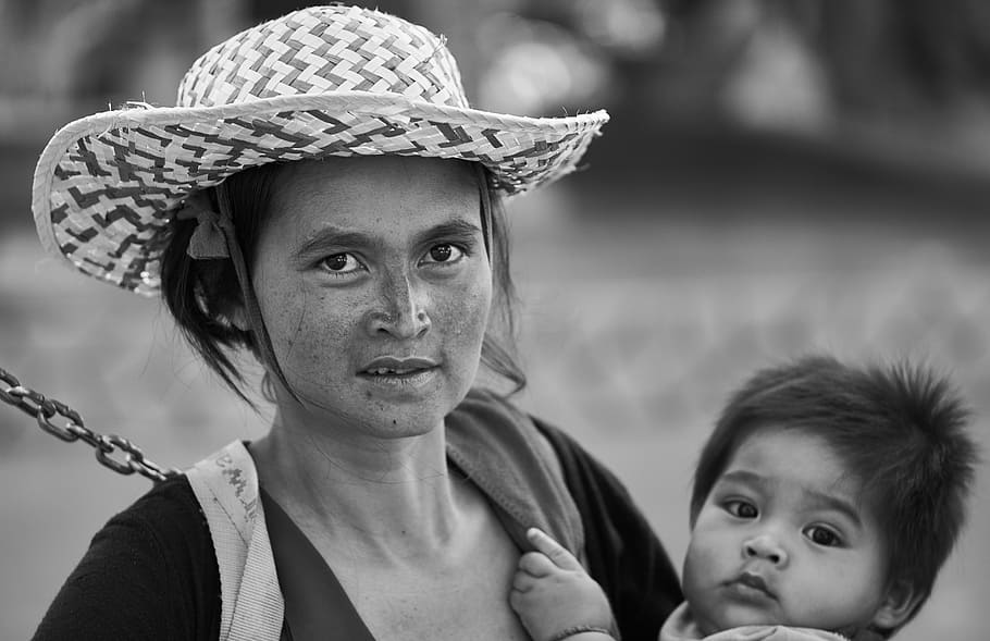 grayscale photo of woman carrying baby, mom, hat, women's, documentary