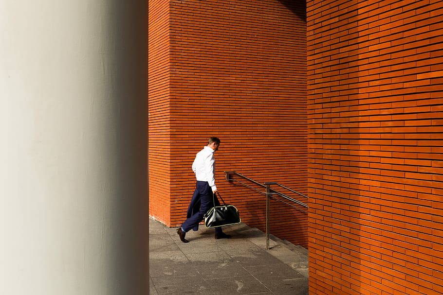 man holding duffel bag down stair, person walking towards stair carrying bag HD wallpaper