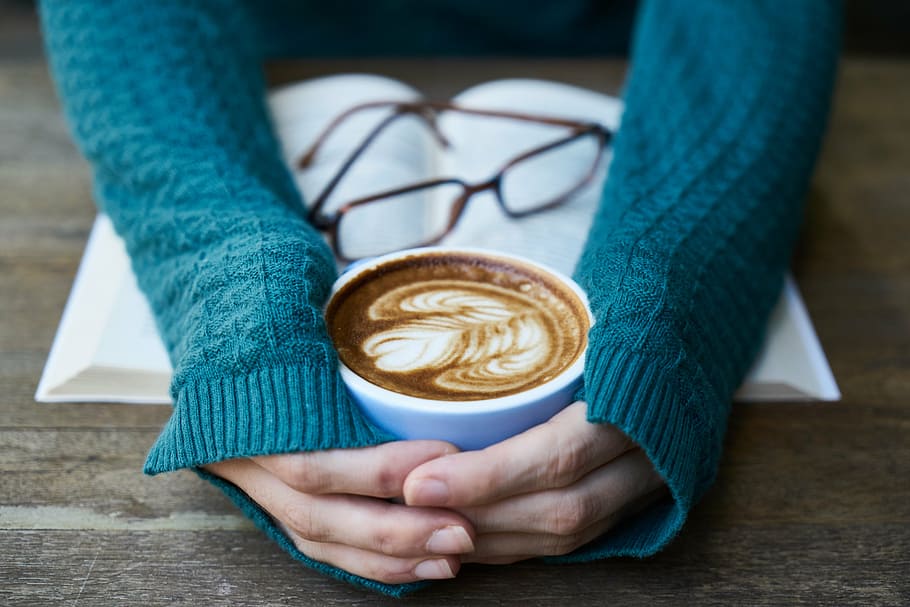 person's hand holding white ceramic coffee mug filled with latte, HD wallpaper