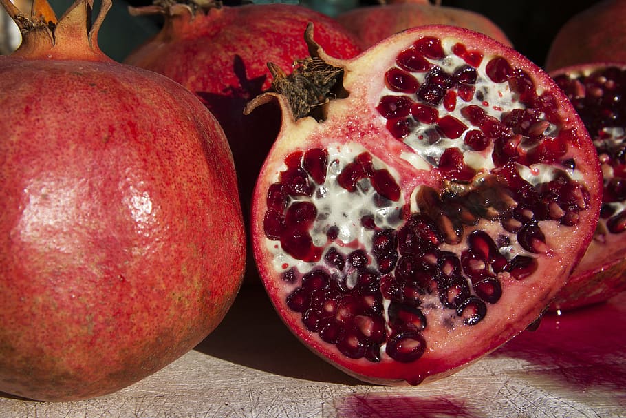 red pomegranate fruits, sliced, delicious, healthy, vitamins