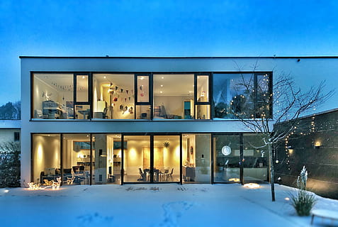 Warm open winter house, glass house across snow covered ground HD wallpaper