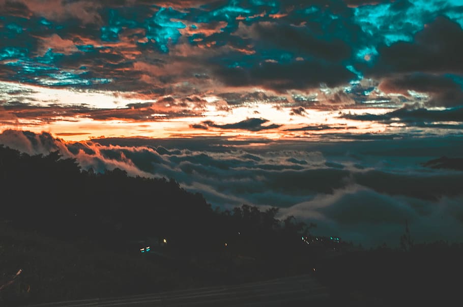 top view of mountain covered by clouds, landscape photography of mountain and trees under clouds HD wallpaper