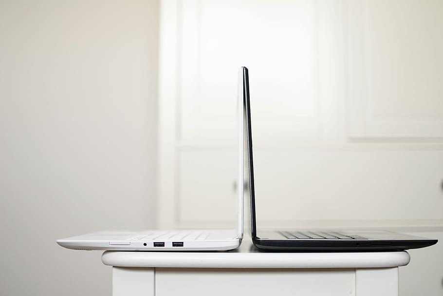 black and white laptop on table back to back, white and black laptop computers HD wallpaper