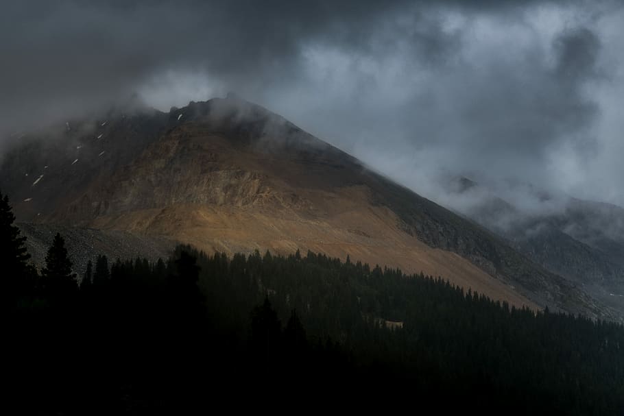 mountain range near forest under cloudy skies, landscape photo of mountains covered by clouds HD wallpaper
