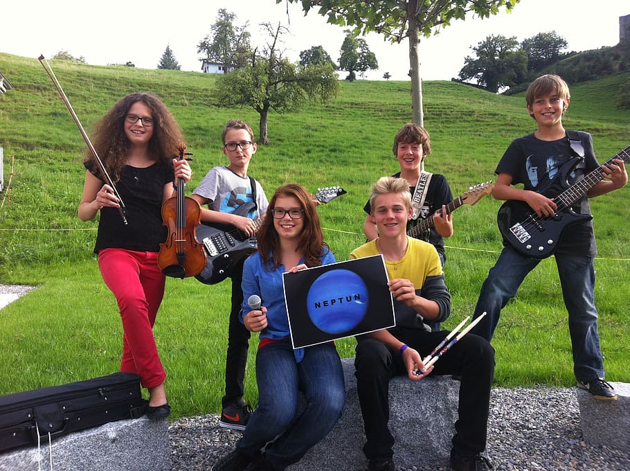 group of people holding musical instruments, music students, musical instruments and teachers