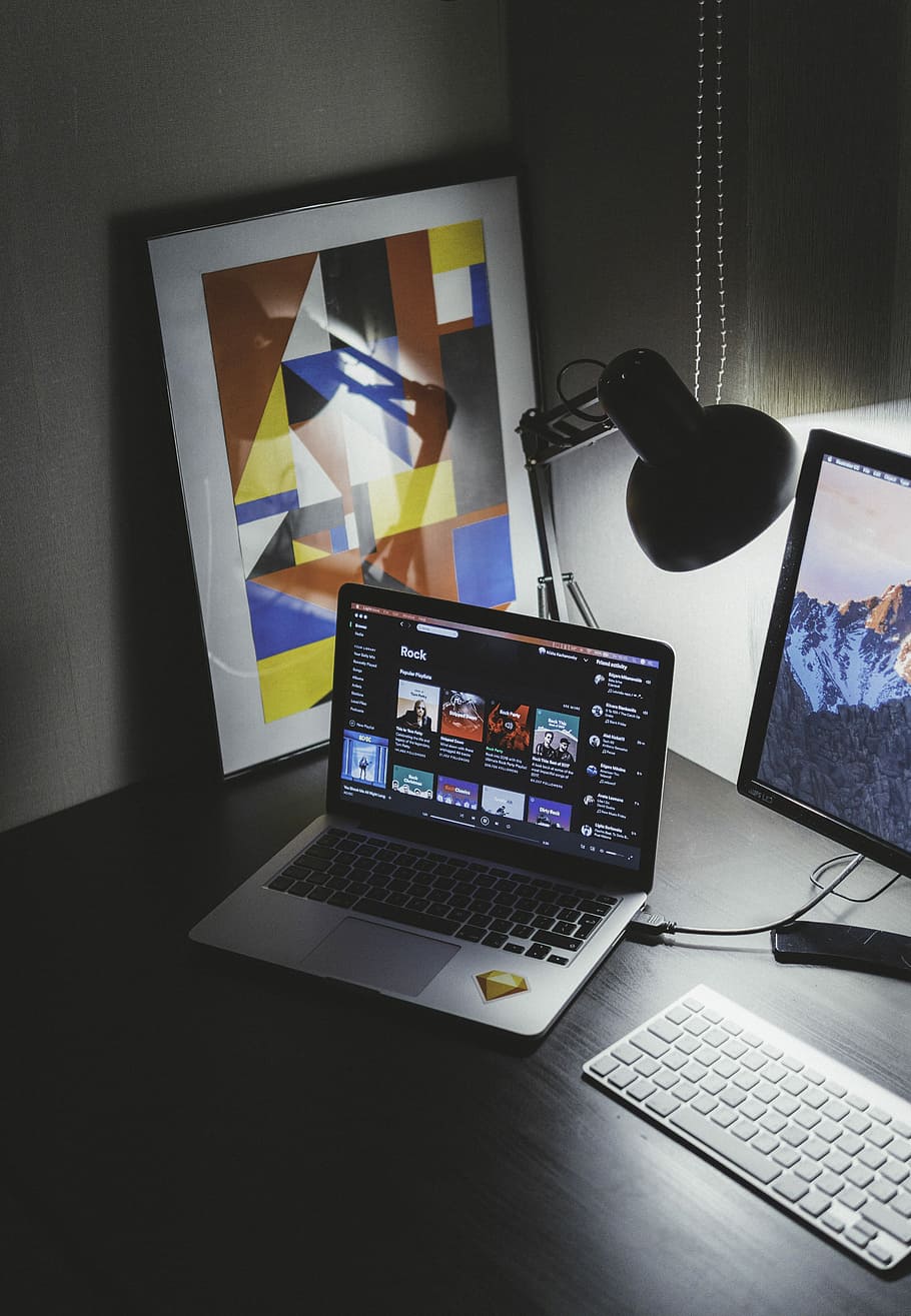 turned on MacBook on table beside iMac, MacBook Pro on black wooden table, HD wallpaper