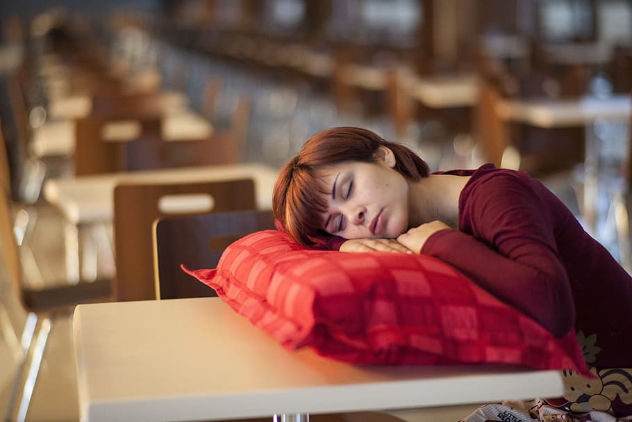 woman in red long-sleeved shirt leaning on red pillow on table HD wallpaper