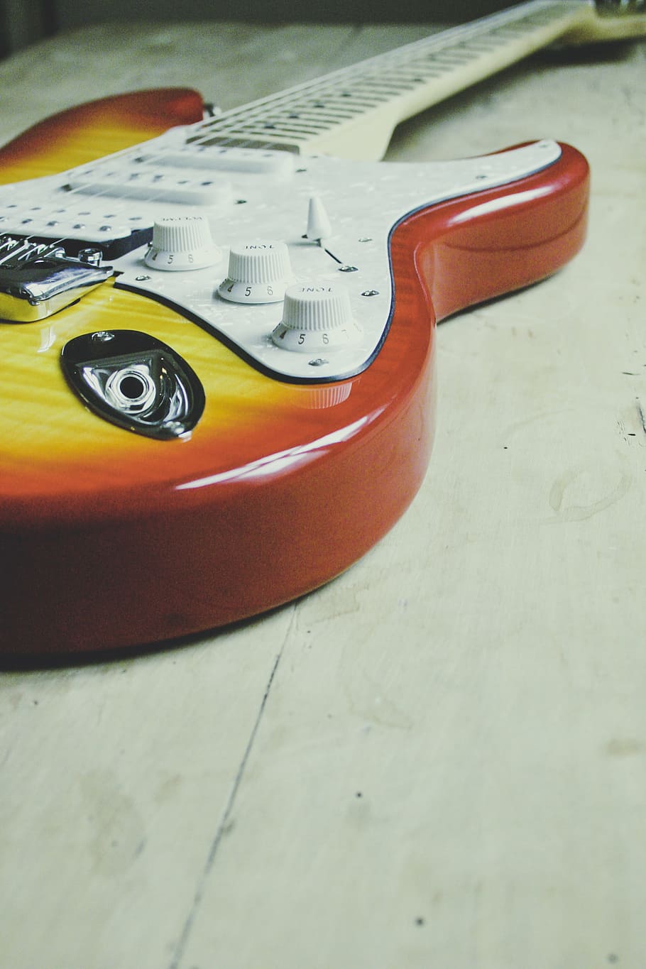 red and yellow electric guitar on white surface, strings, musical HD wallpaper