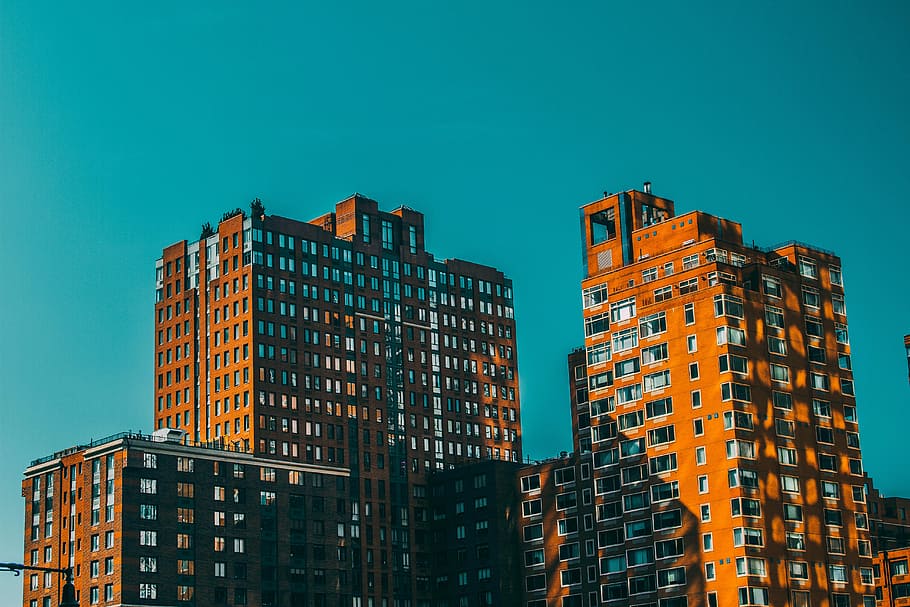 low angle photo of orange high rise building, aerial shot of buildings HD wallpaper