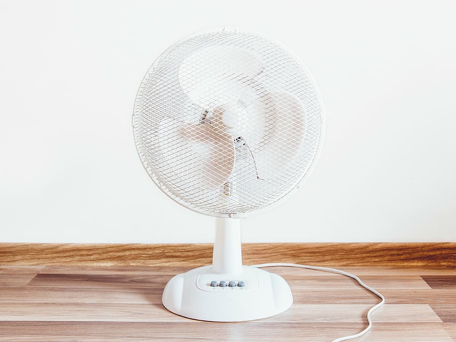 turned-off white desk fan on floor, objects, hardwood, wall, indoors
