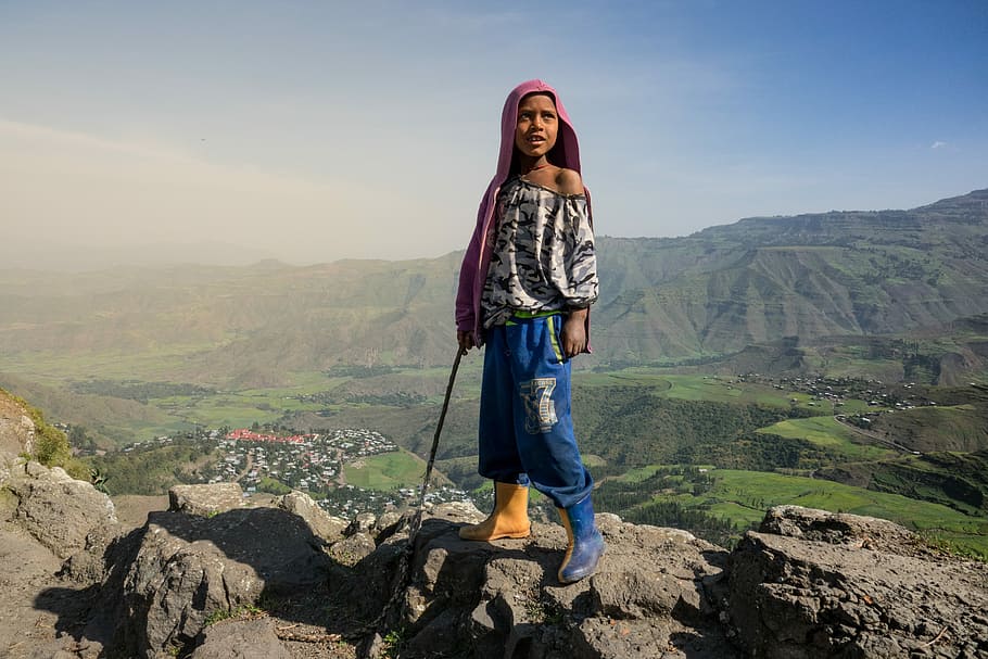 Hike in Lalibela, Ethiopia, woman standing on gray rock formation, HD wallpaper