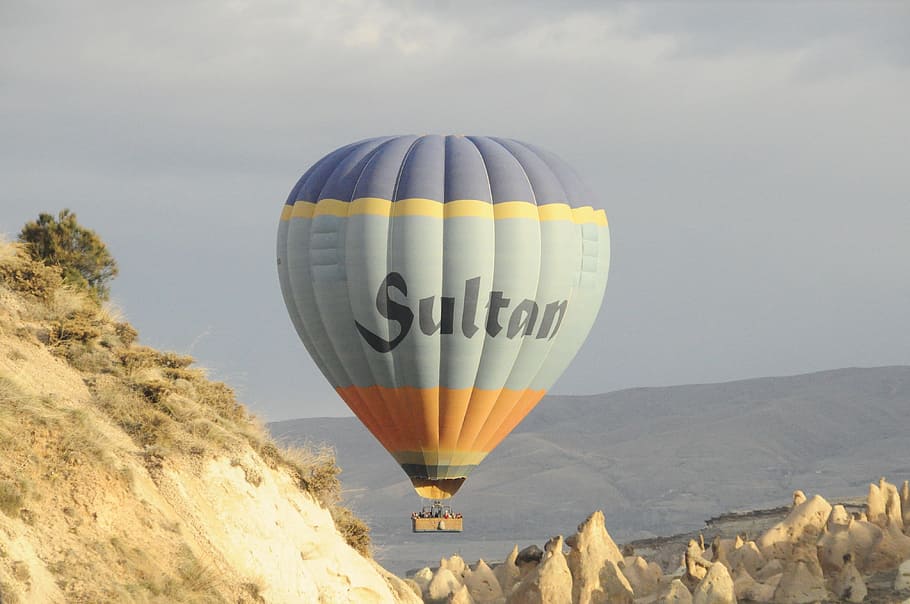 photo of gray, orange and blue Sultan hot air balloon during daytime
